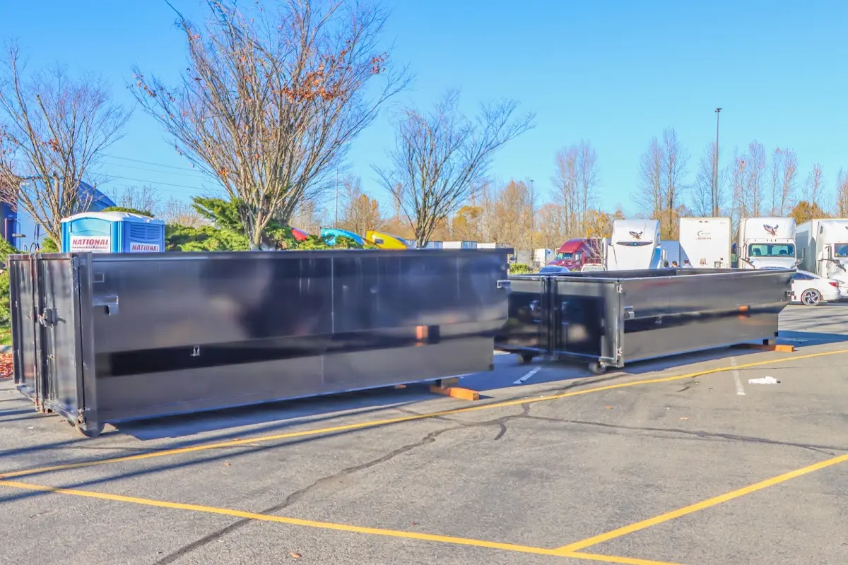 Professional dumpster rental service with roll-off container on residential driveway in Charter Oak